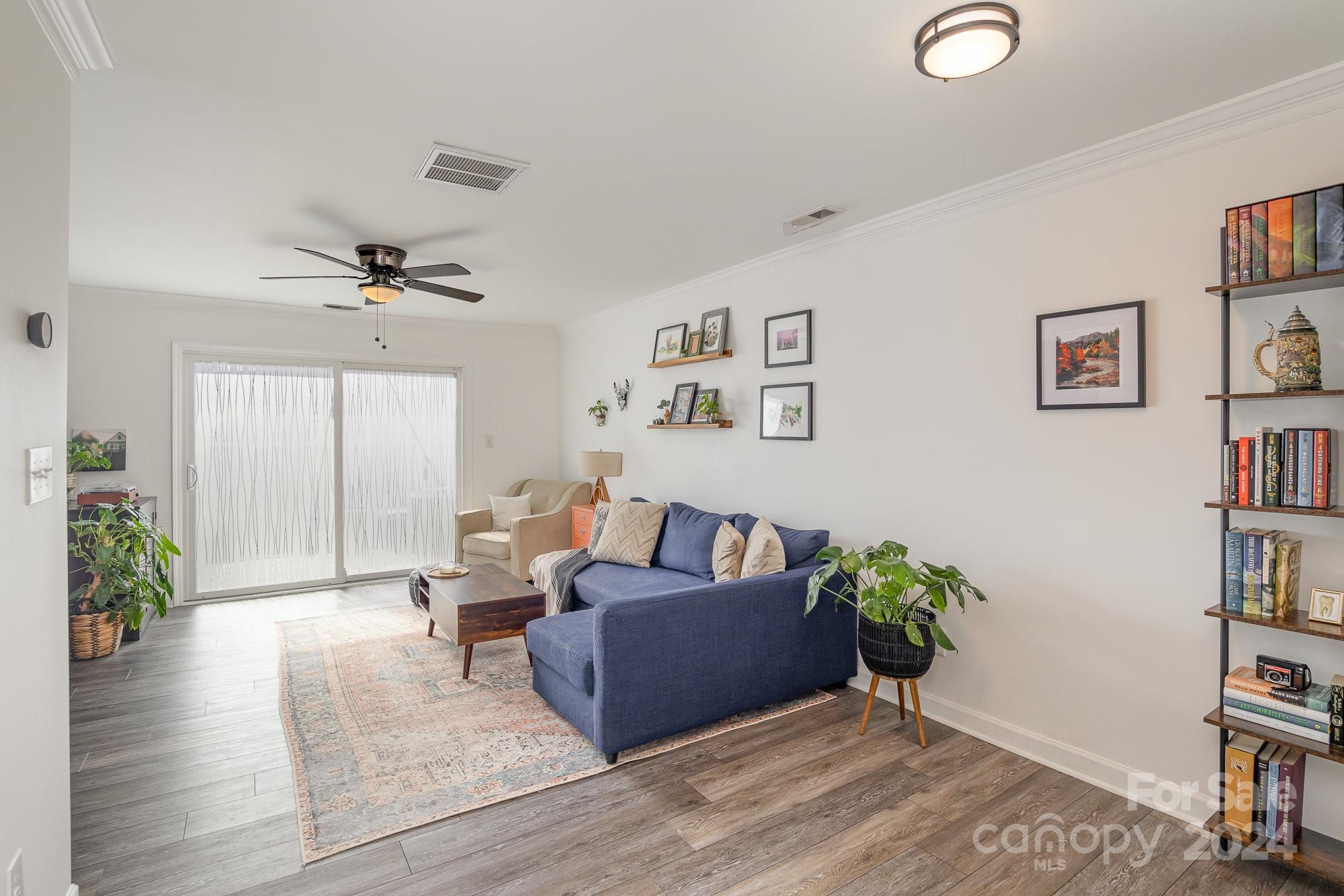 a living room with furniture and a bookshelf