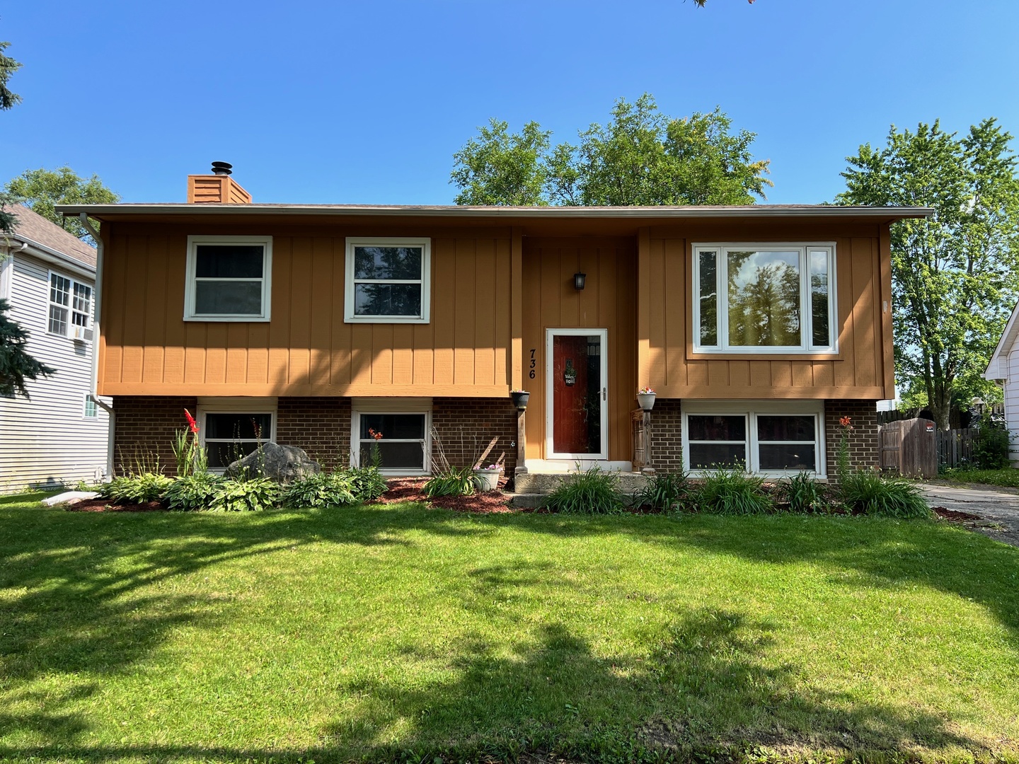 a front view of a house with garden