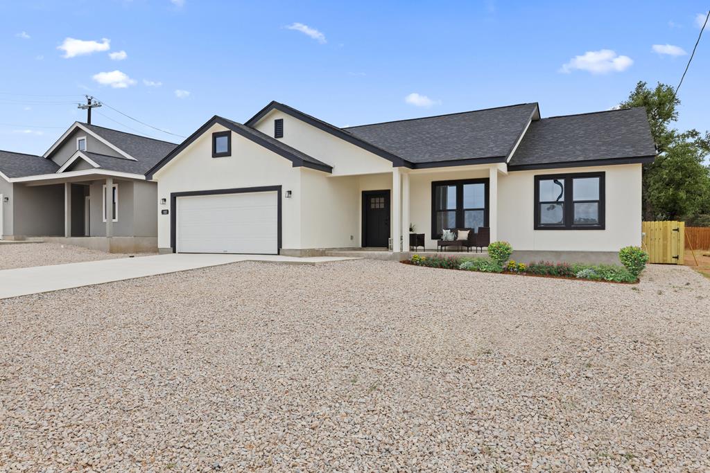 a front view of a house with yard and garage