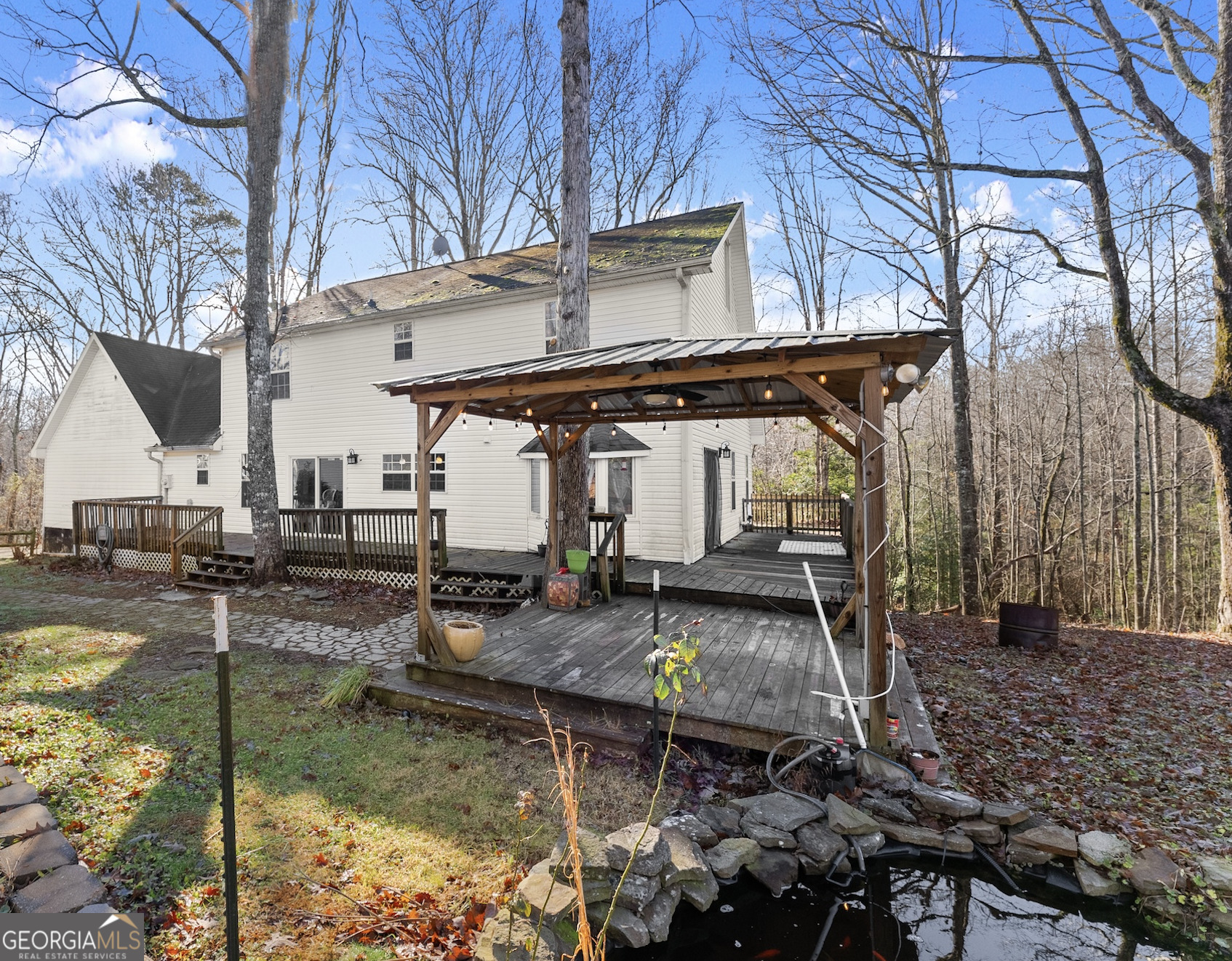 a backyard of a house with barbeque oven