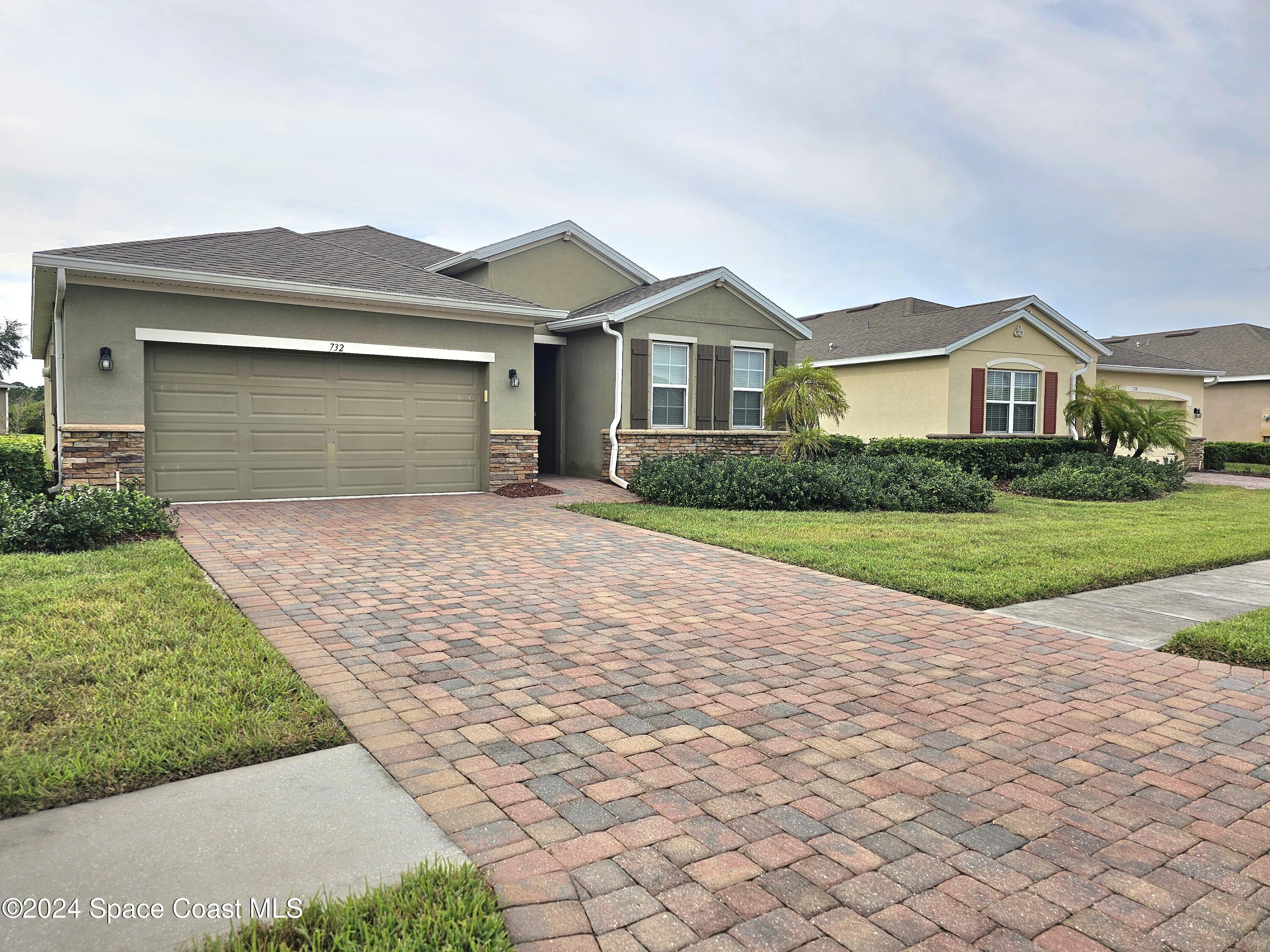 a front view of a house with yard