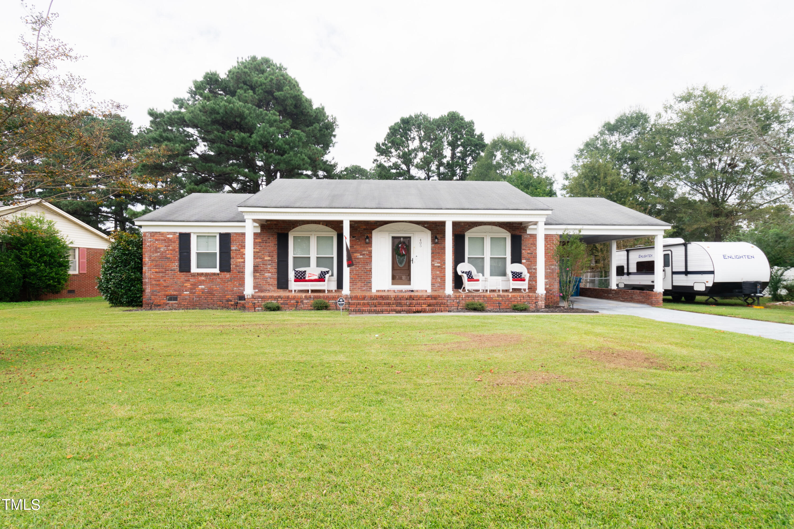 a front view of a house with a garden