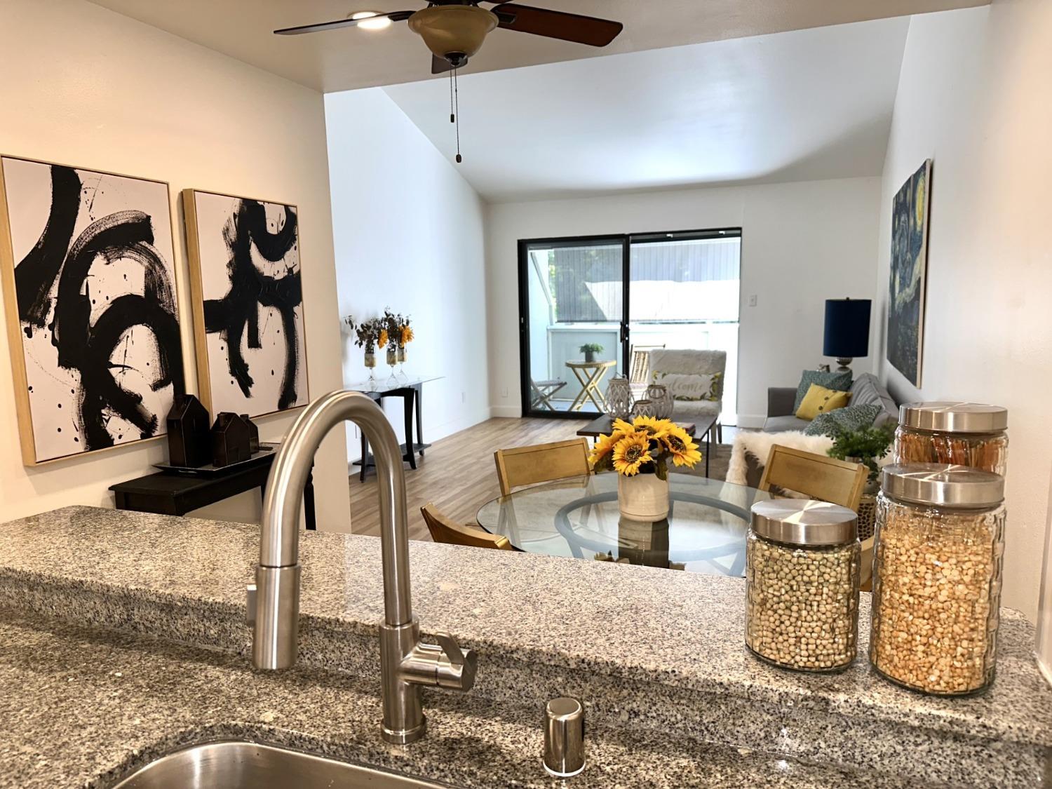 a kitchen with a sink appliances and a chandelier