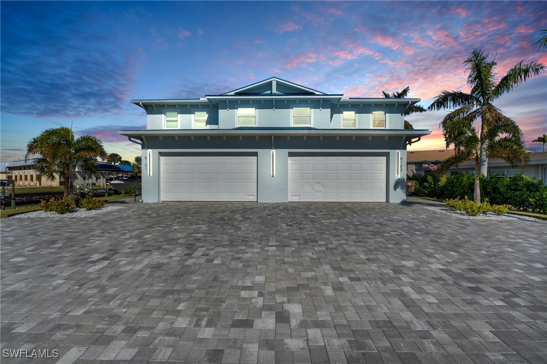 a front view of a house with a yard and garage