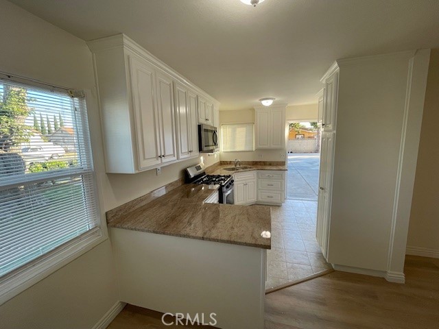 a kitchen with sink refrigerator and window