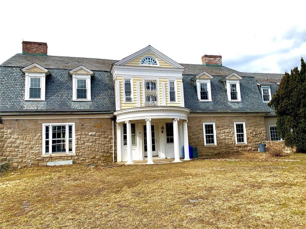 a front view of a house with a garden