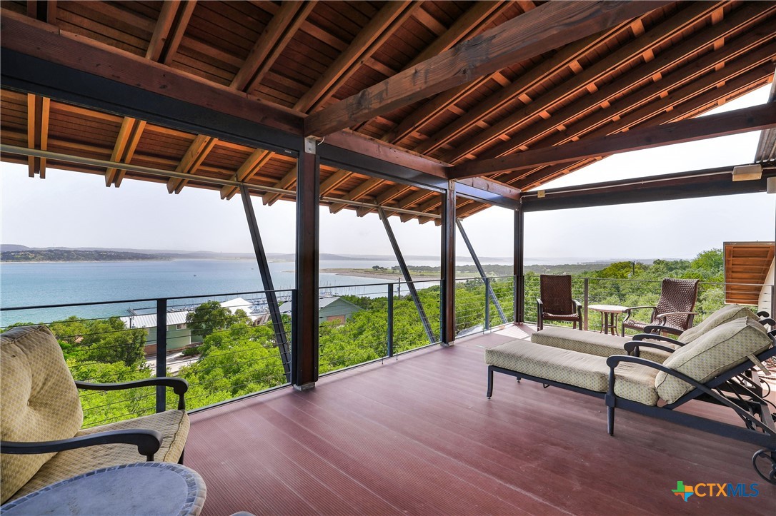 a living room with patio furniture and a floor to ceiling window