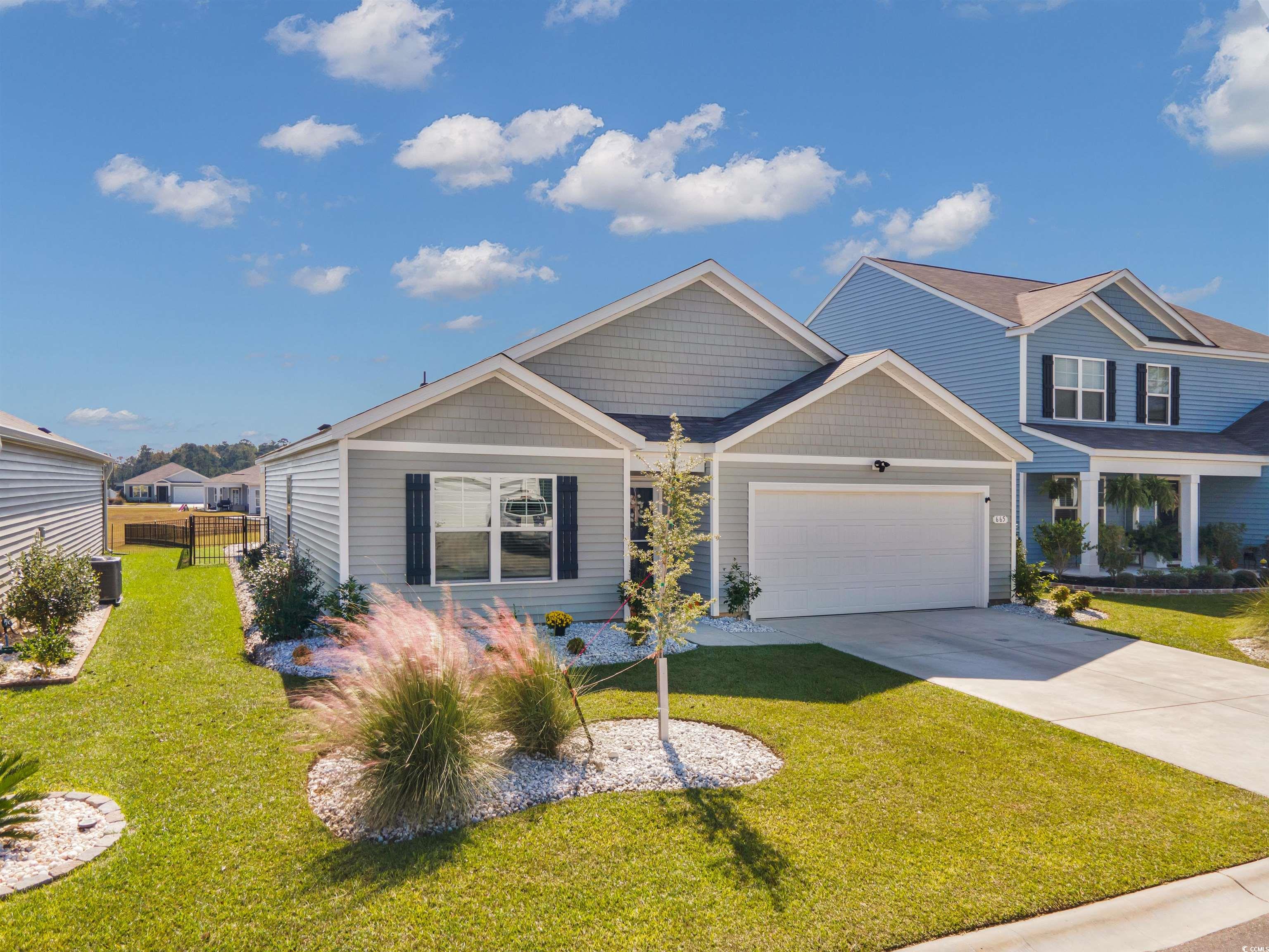 View of front of property featuring a front lawn a