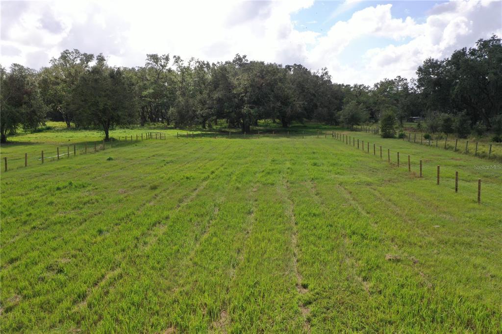 a view of outdoor space with green field and trees