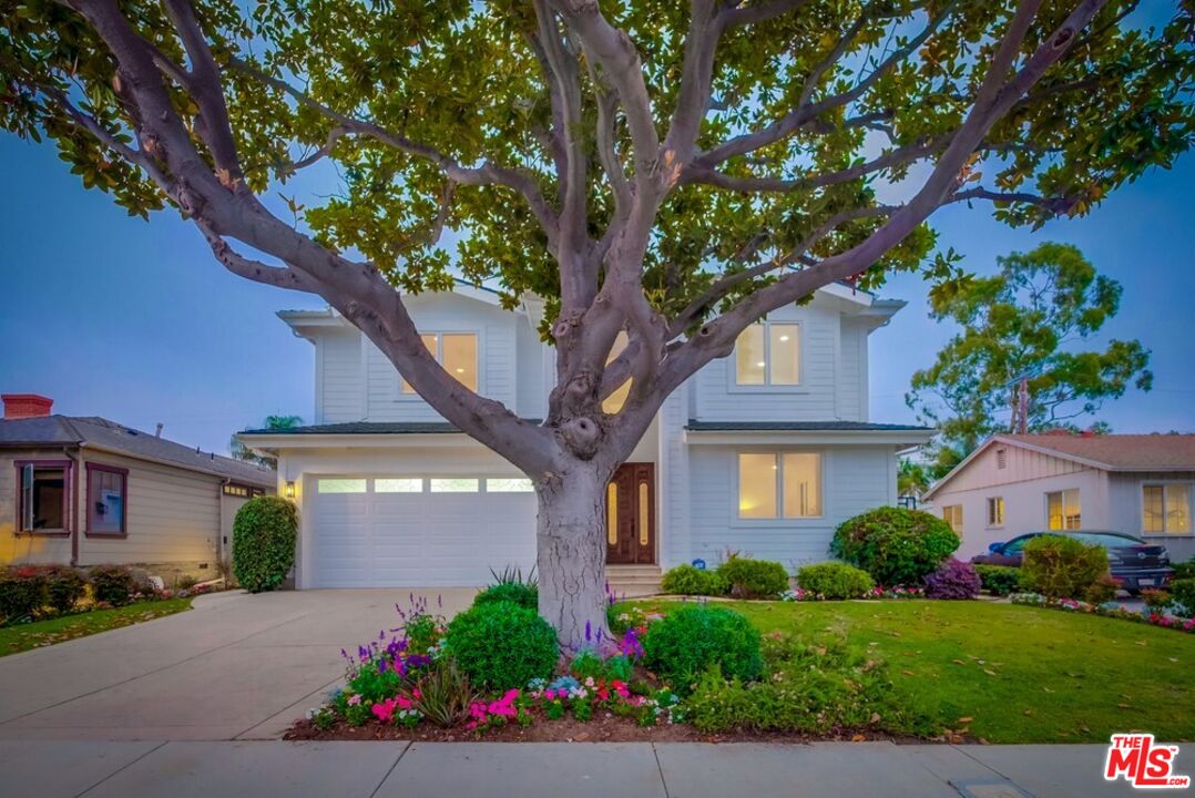 a front view of a house with a garden