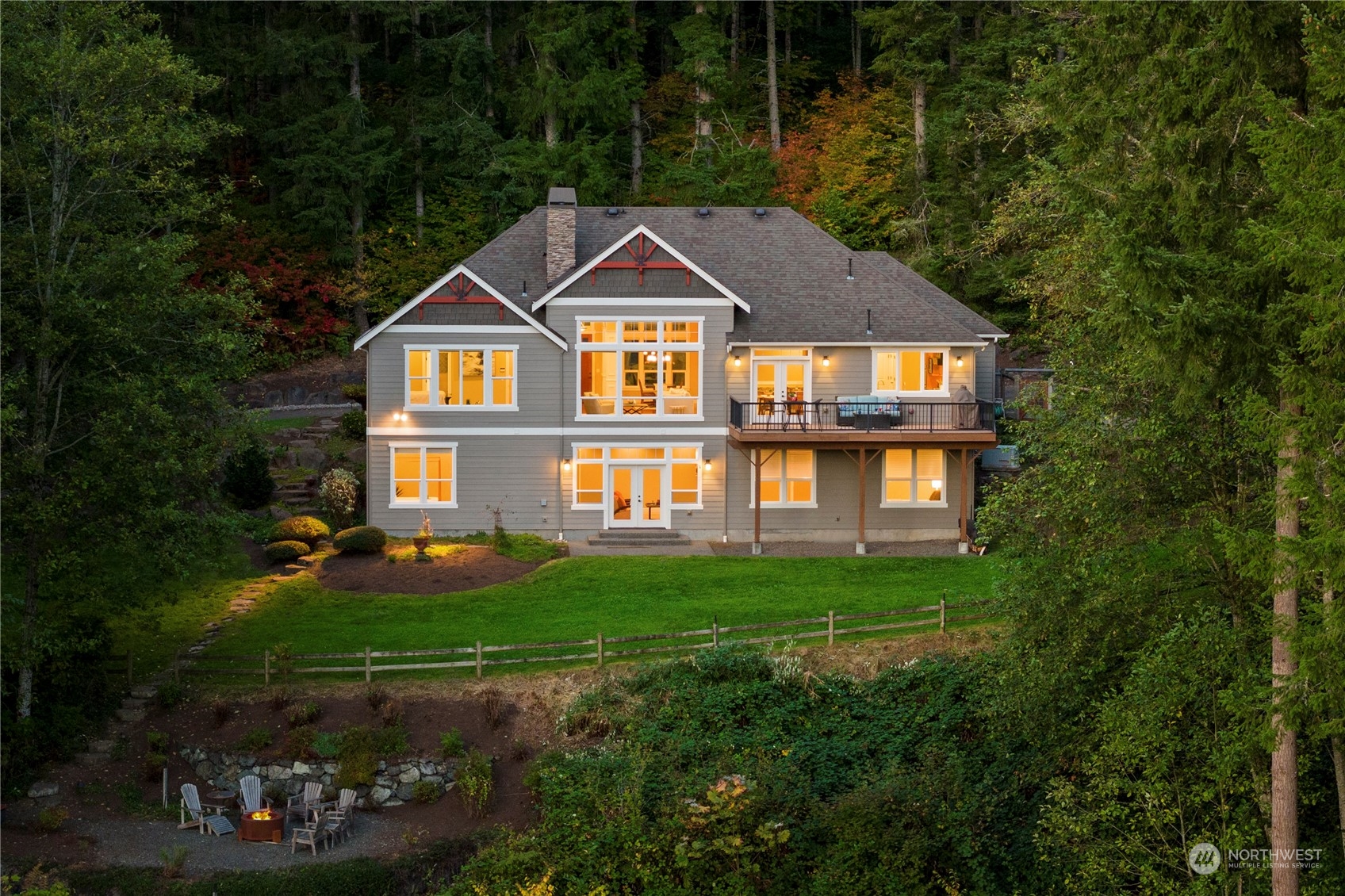 a front view of a house with a yard and trees