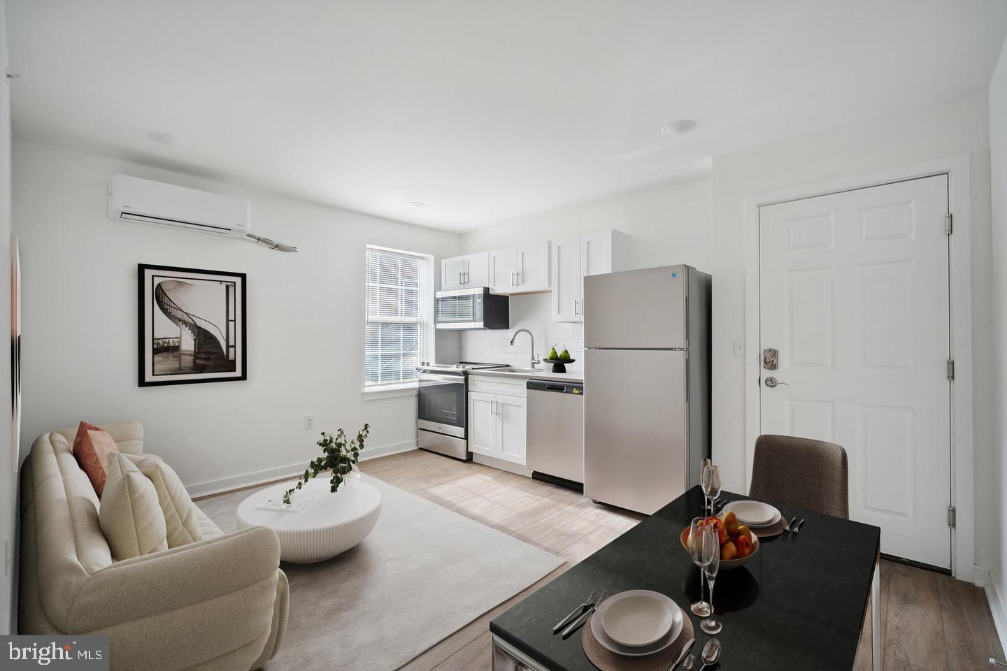 a living room with furniture and kitchen appliances