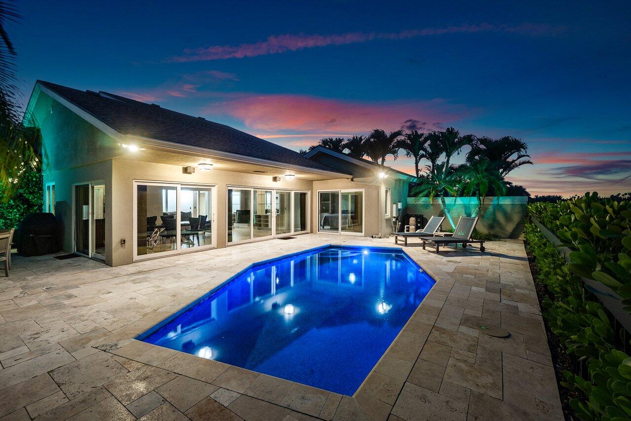 a swimming pool with outdoor seating and yard