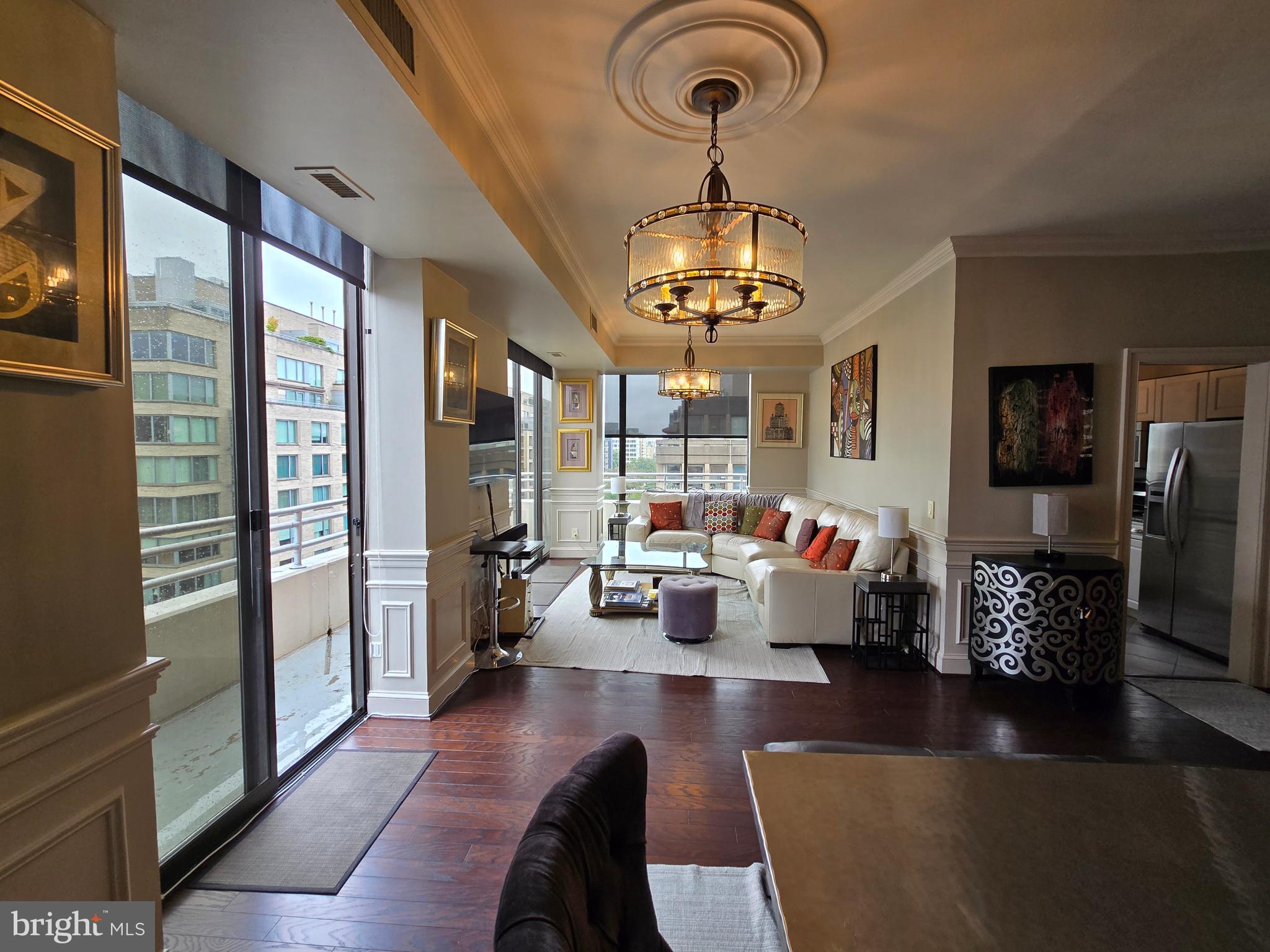 a living room with furniture and a chandelier