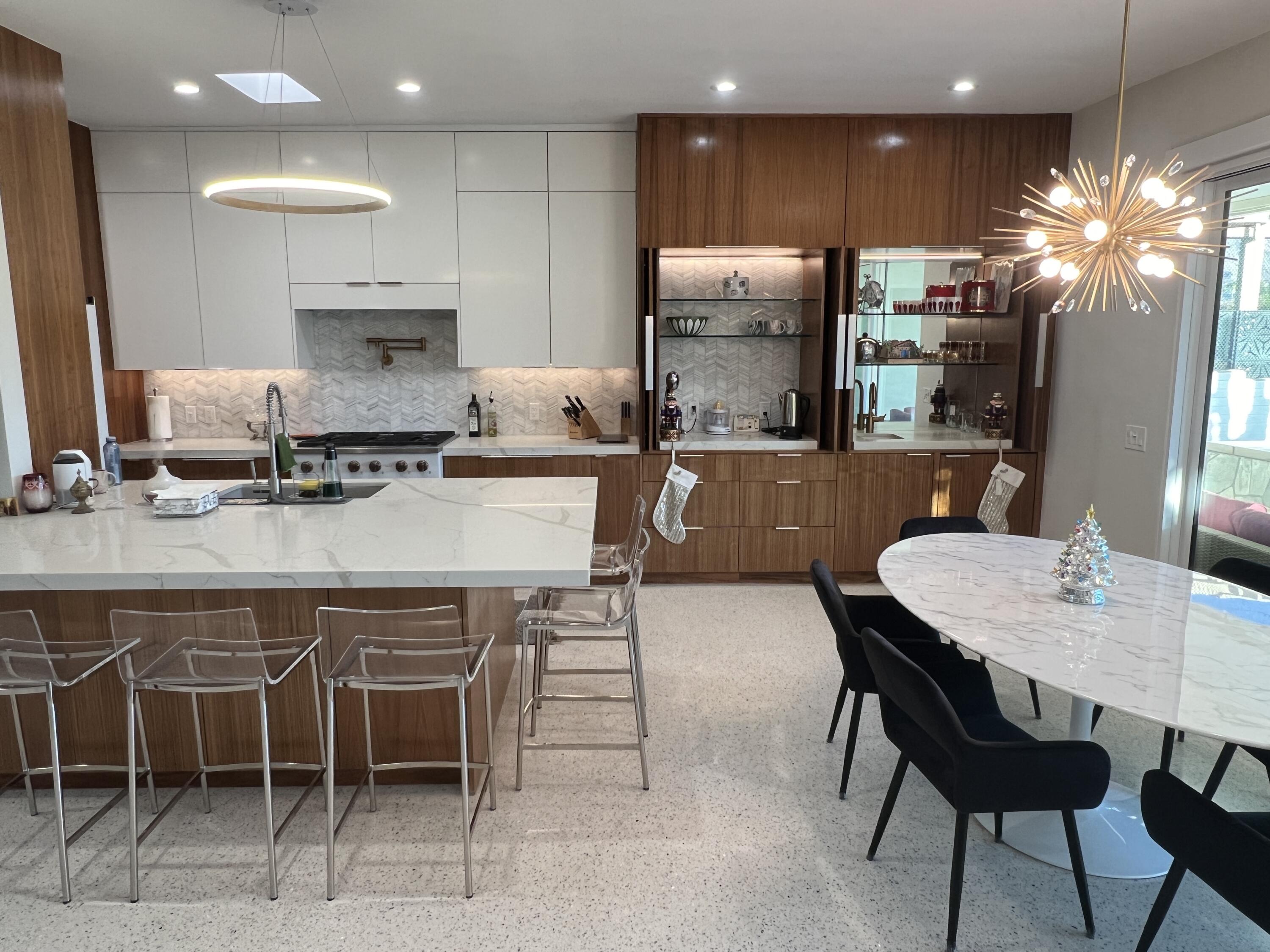 a kitchen with a dining table chairs and refrigerator