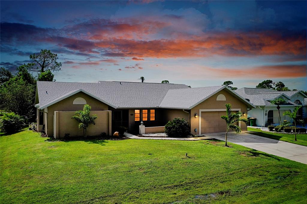 a front view of a house with a yard and garage