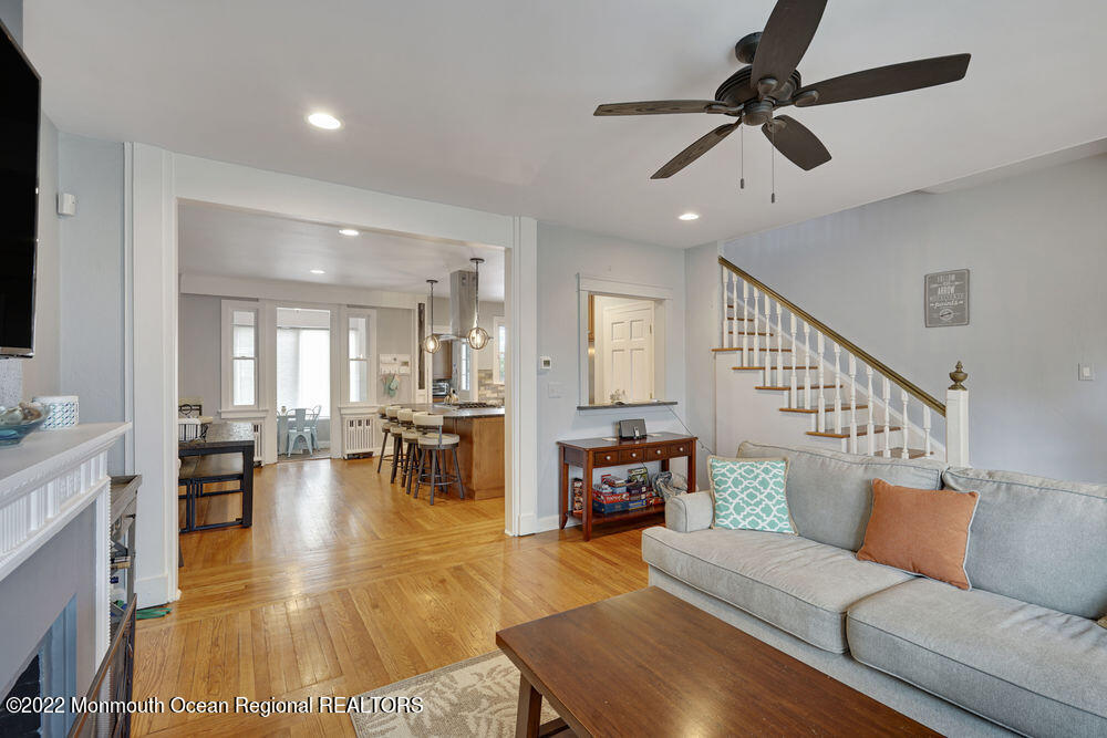 a living room with furniture and a dining table