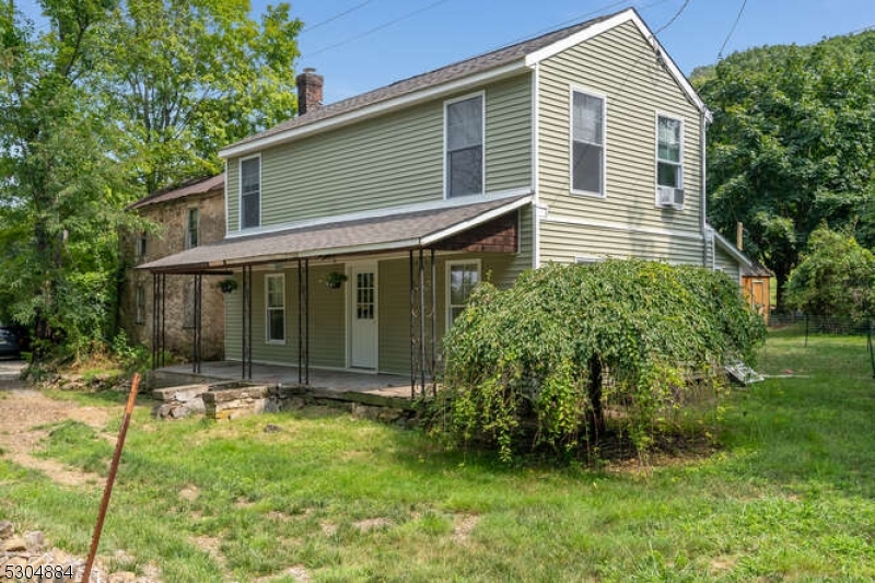 a view of house with backyard