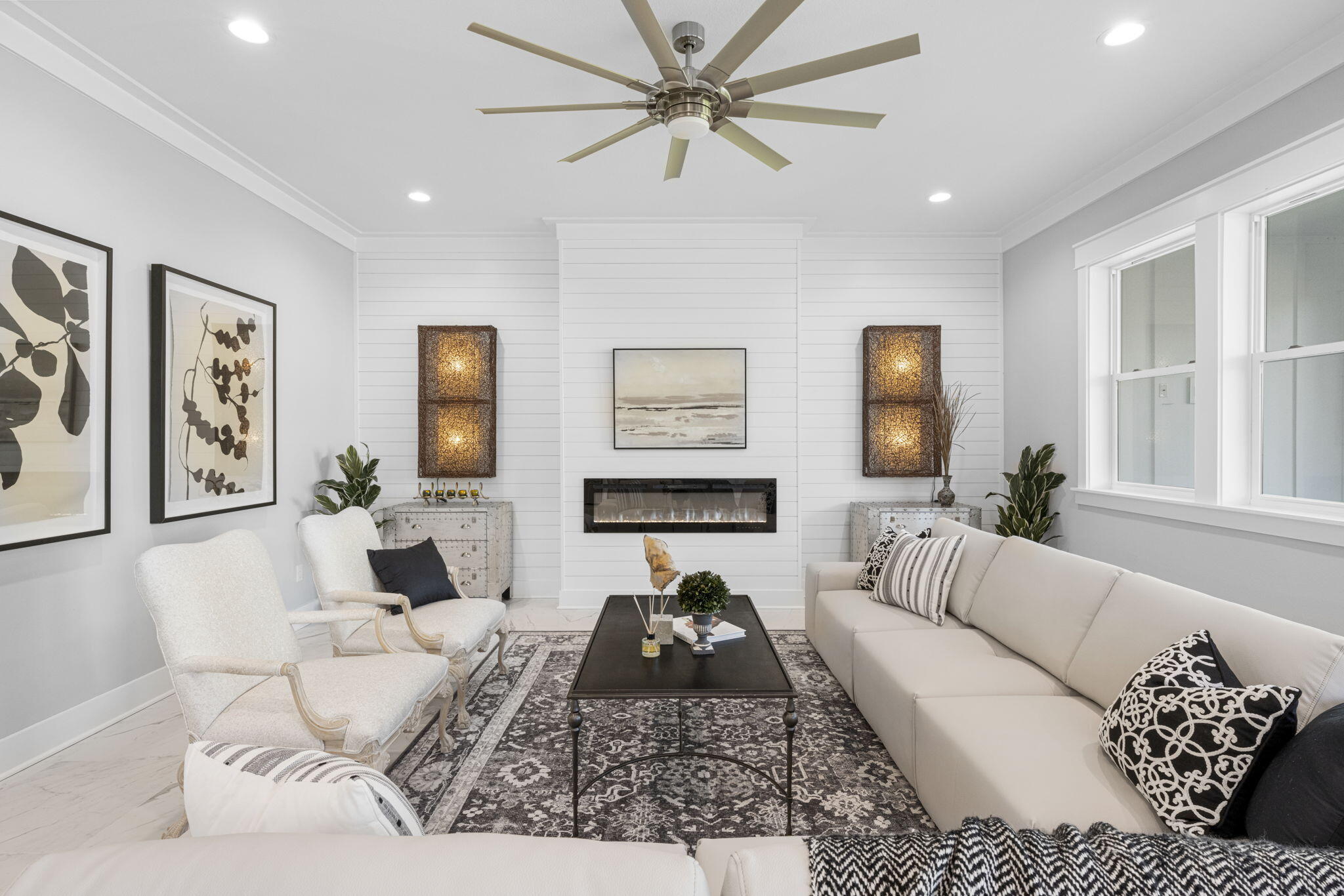 a living room with furniture ceiling fan and a window