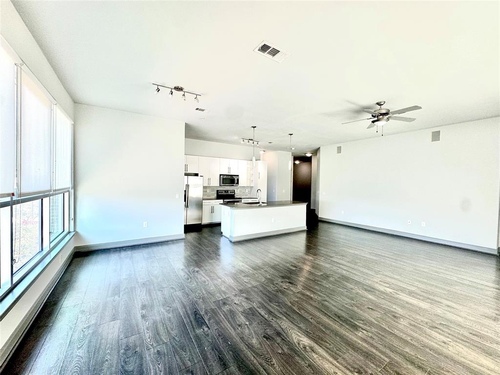 a view of a kitchen with a stove wooden floor and a kitchen view