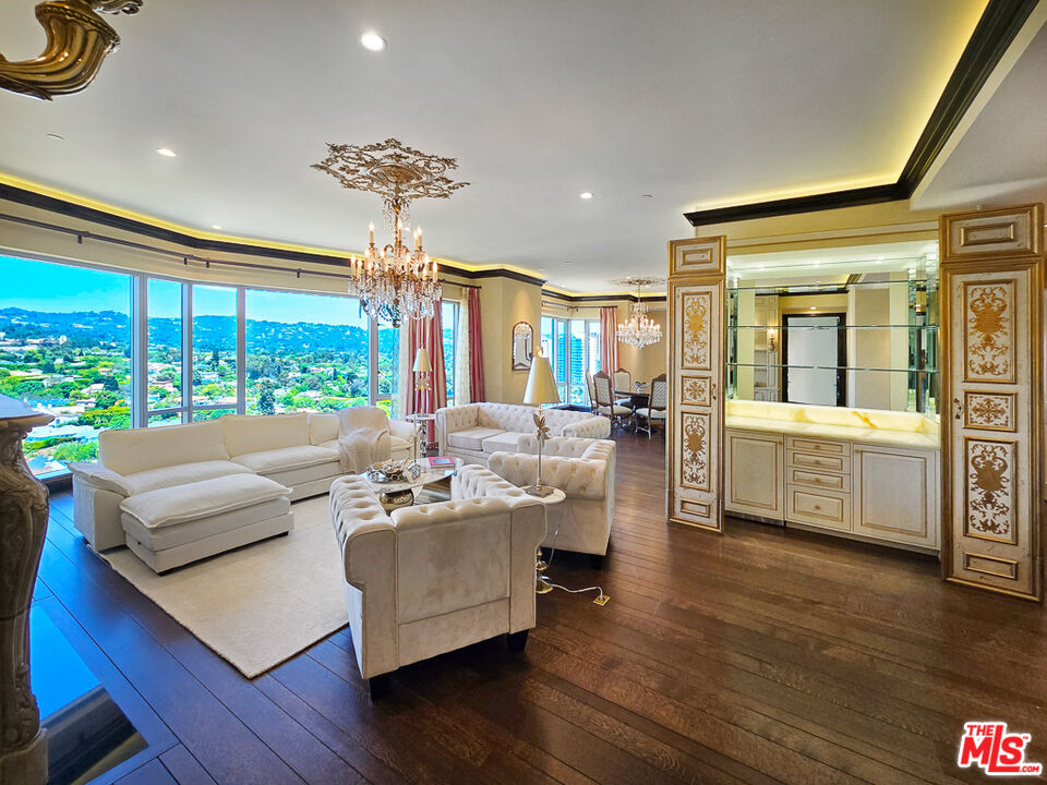 a living room with furniture and large windows