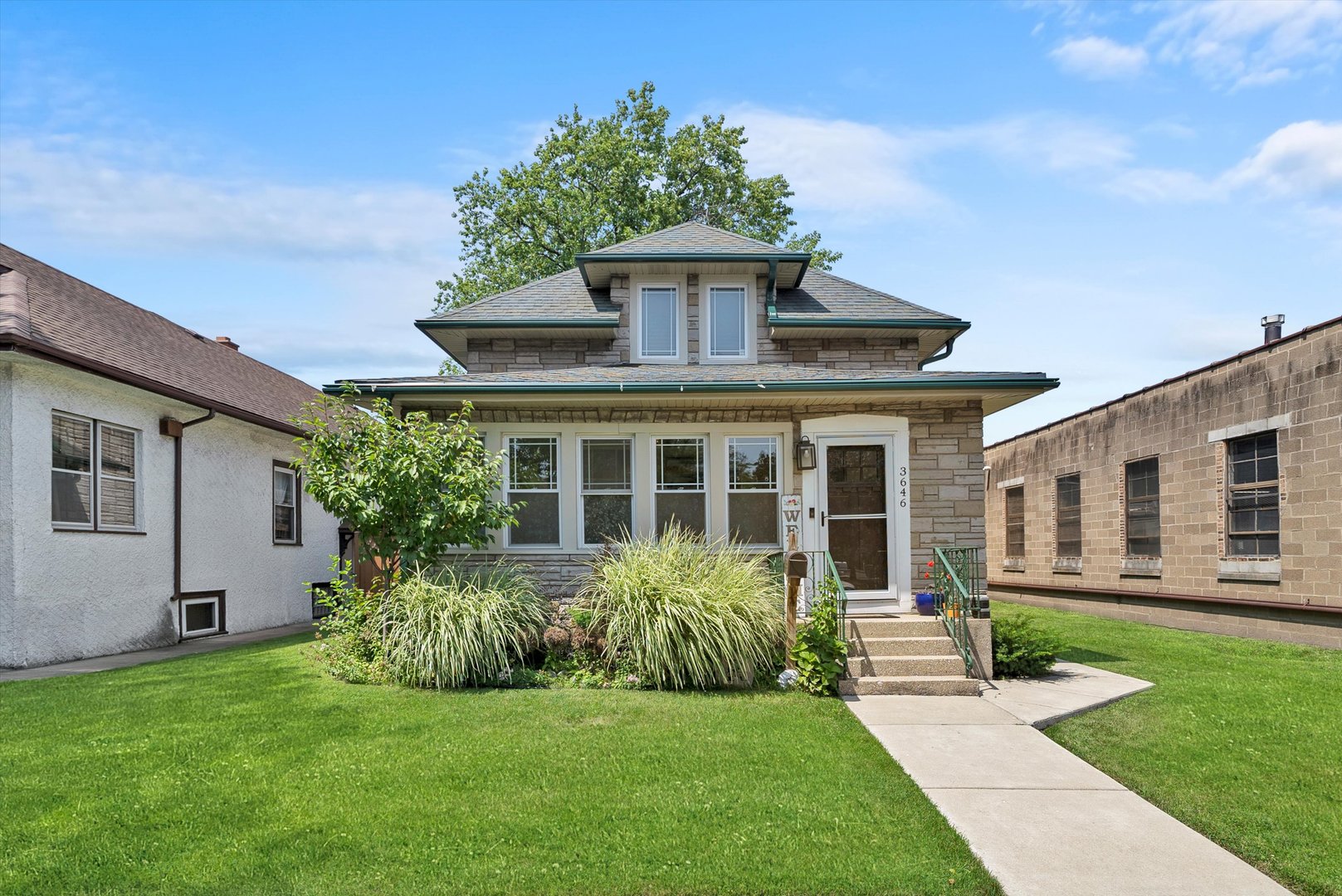 a front view of house with yard and green space