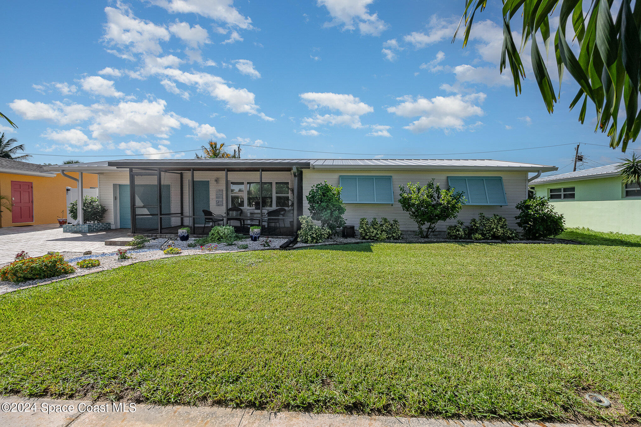 a front view of house with yard and outdoor seating