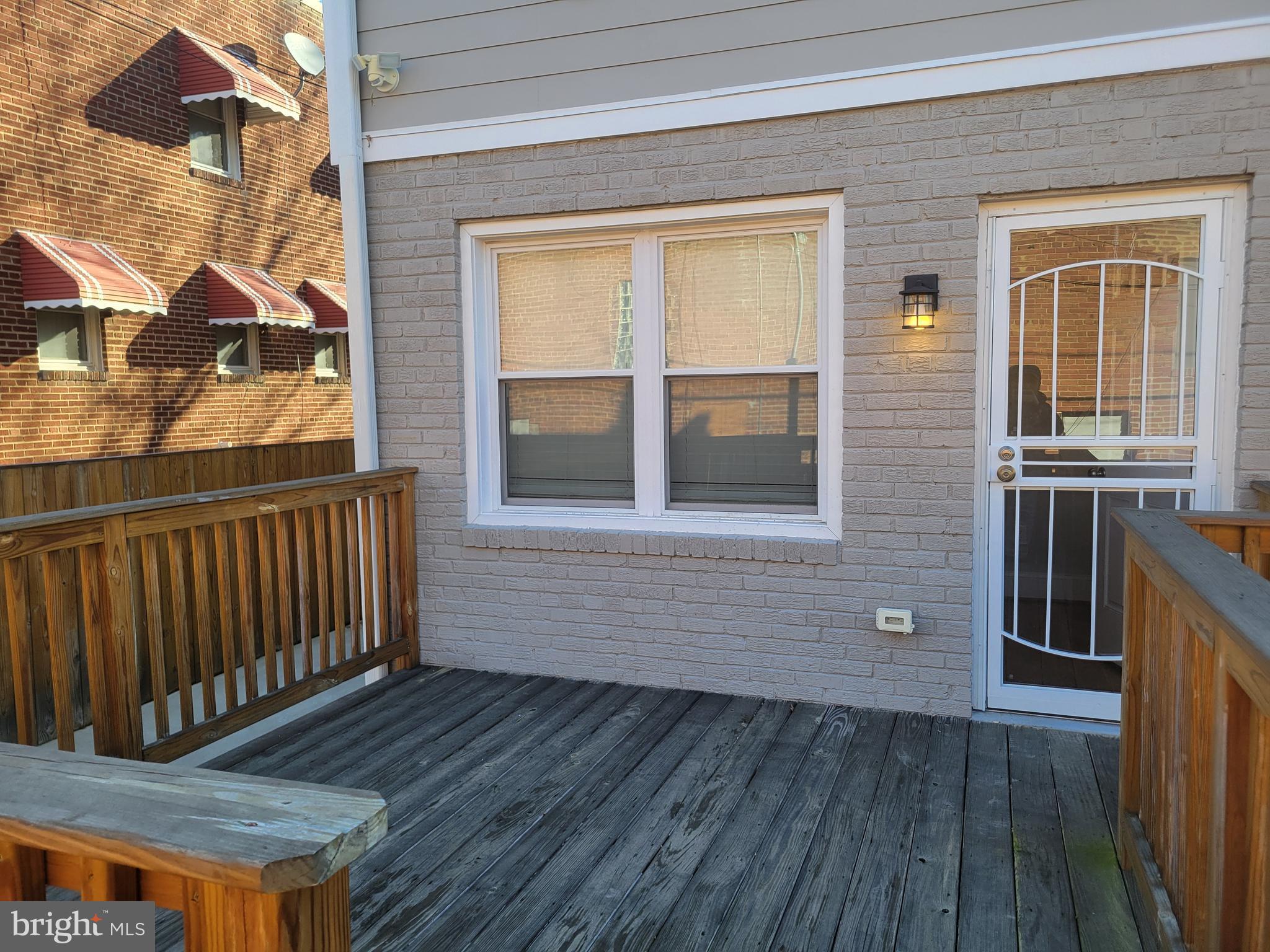 a view of a house with wooden deck