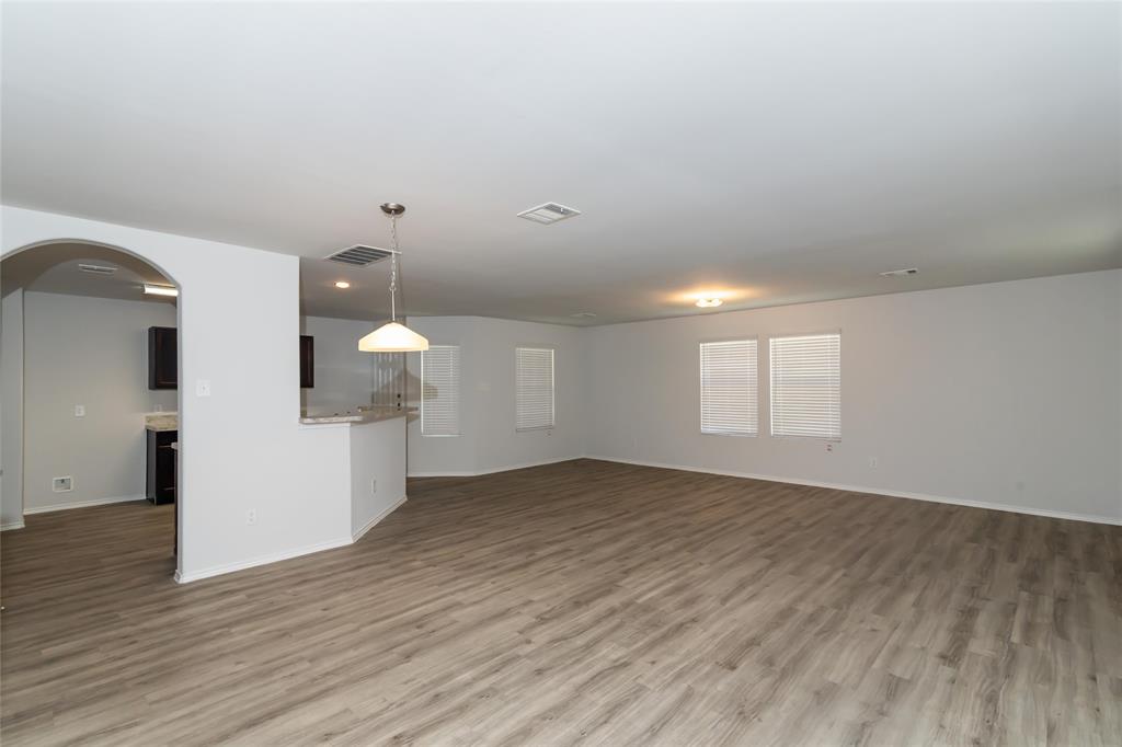 a view of a room with wooden floor and white walls