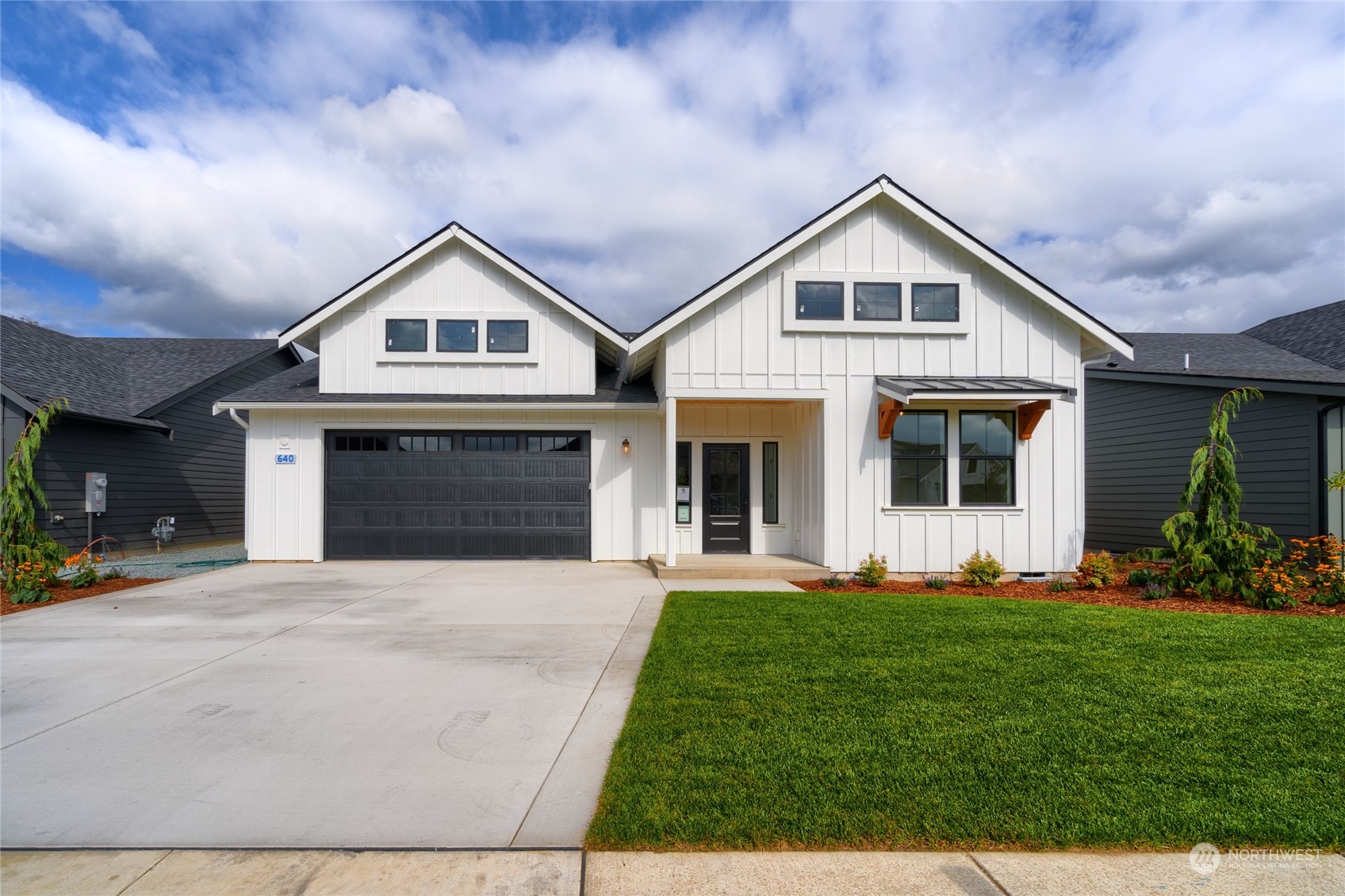 a front view of a house with a yard and garage