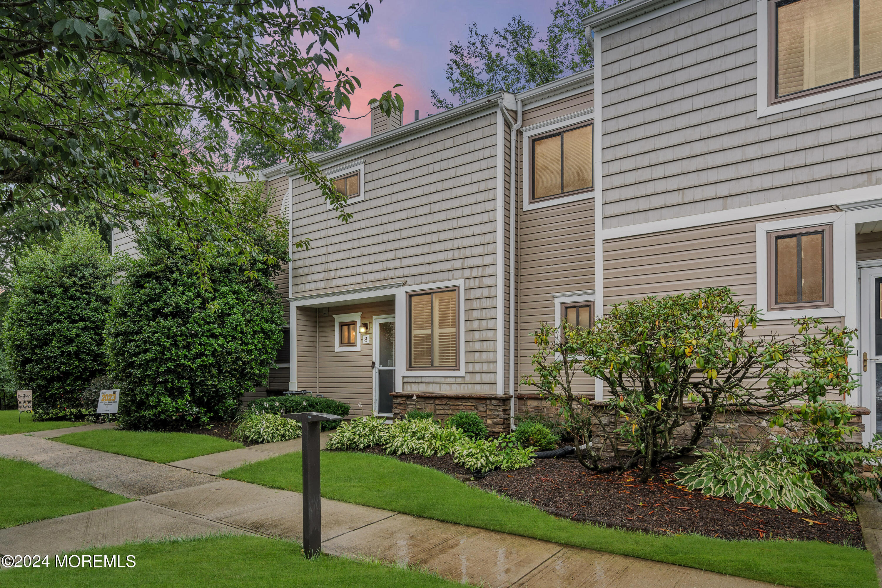 a view of a house with a yard and plants