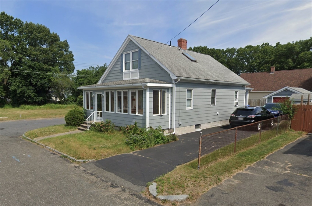 a view of a house with backyard and sitting area