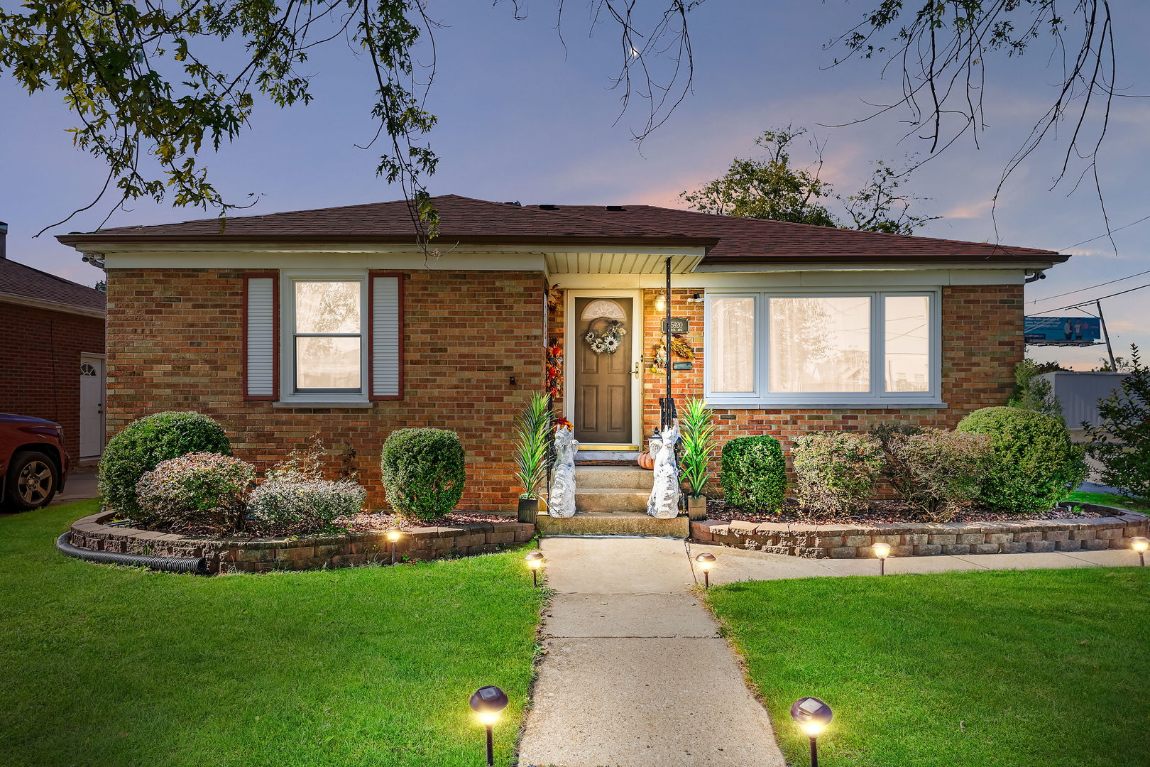 a front view of a house with a garden