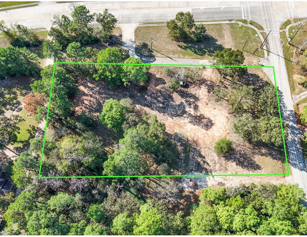 an aerial view of residential house with outdoor space and trees all around