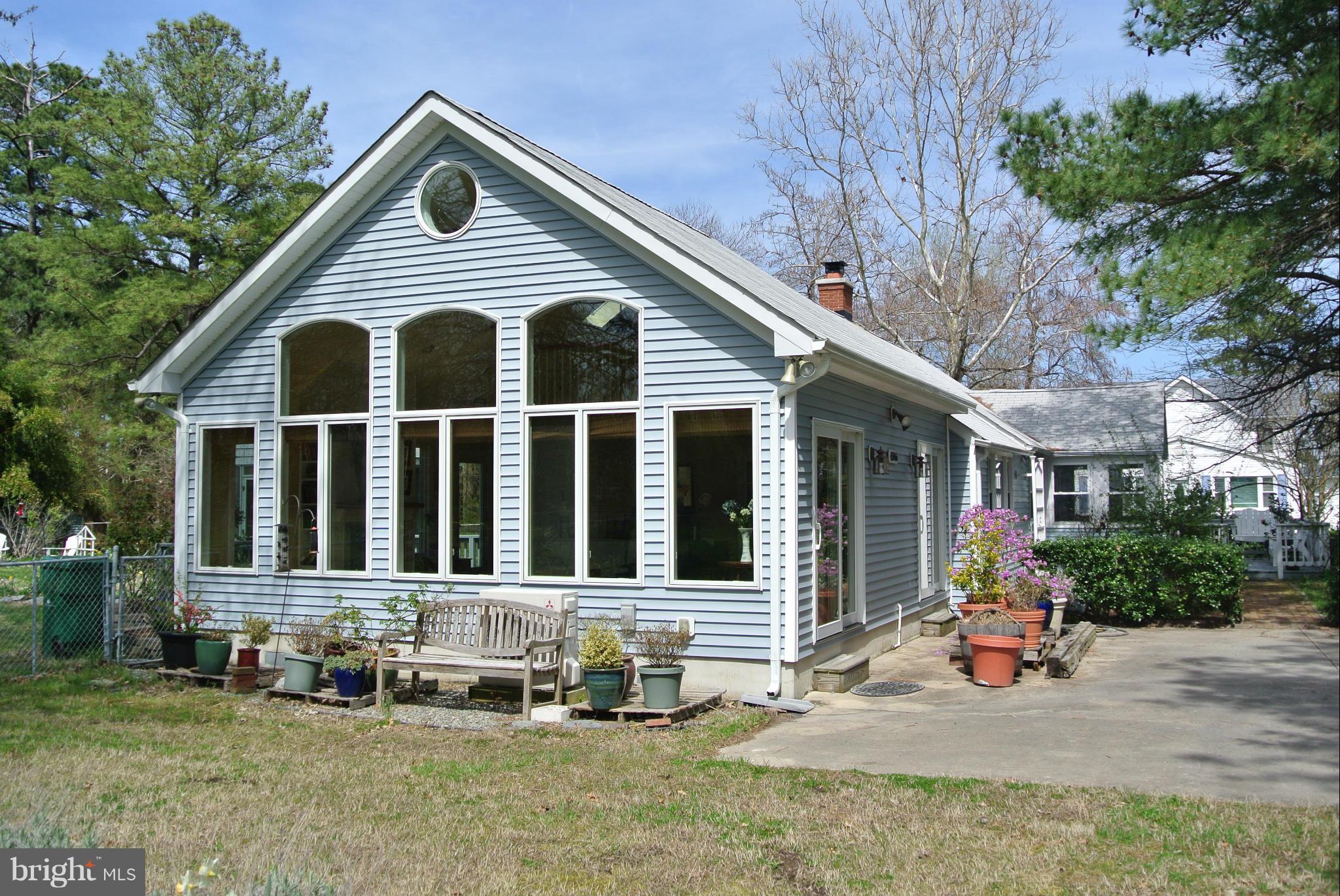 a front view of a house with sitting area