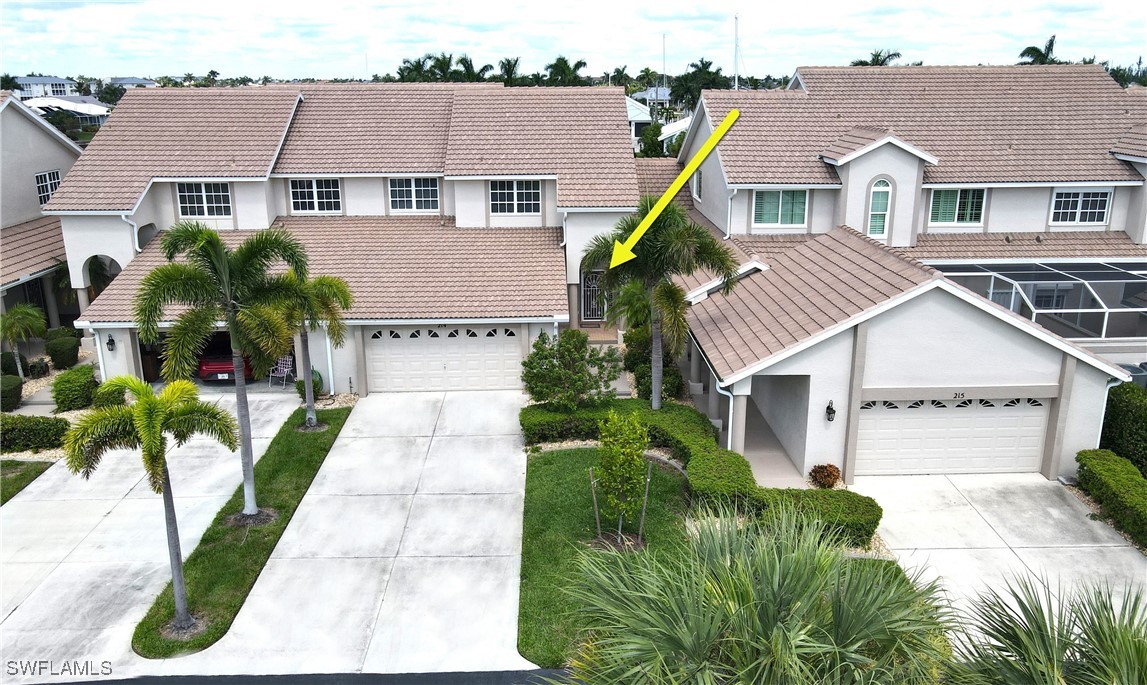 a aerial view of a house with a yard and potted plants