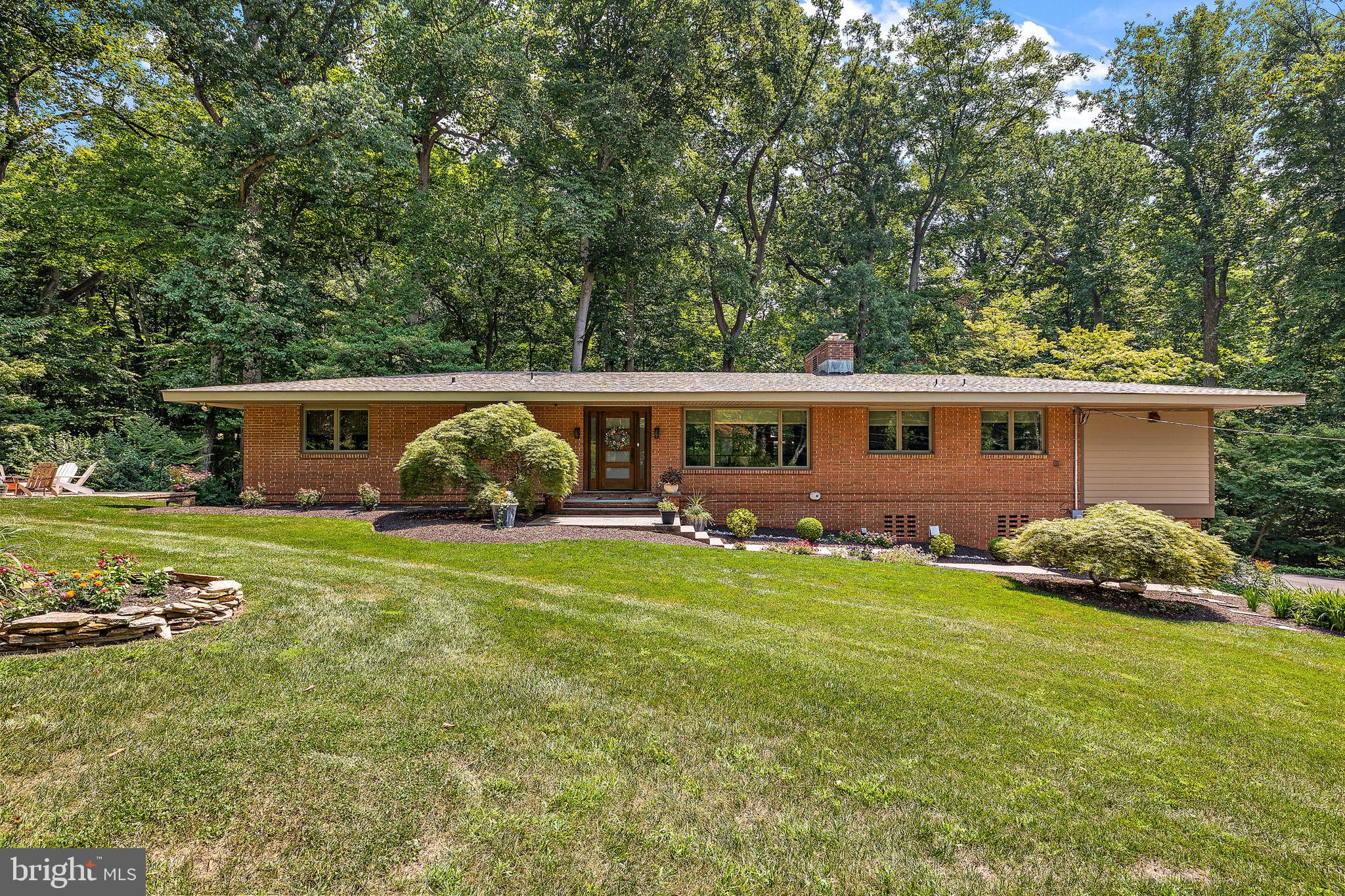 a front view of house with yard and outdoor seating