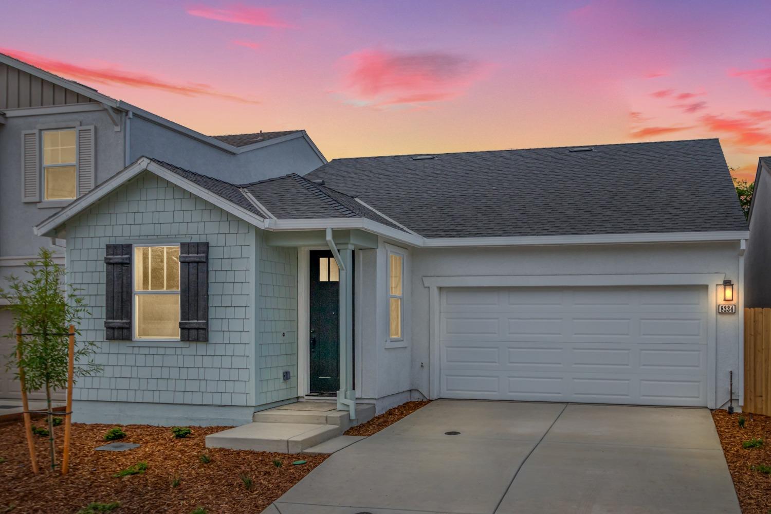 a front view of a house with garage