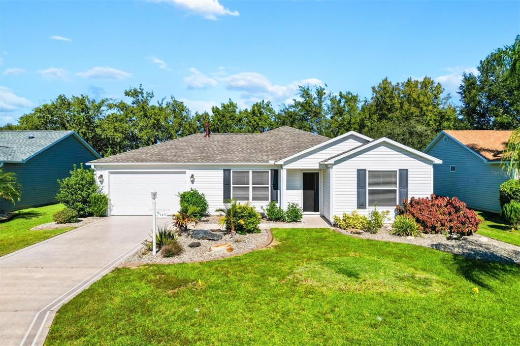 a front view of a house with garden