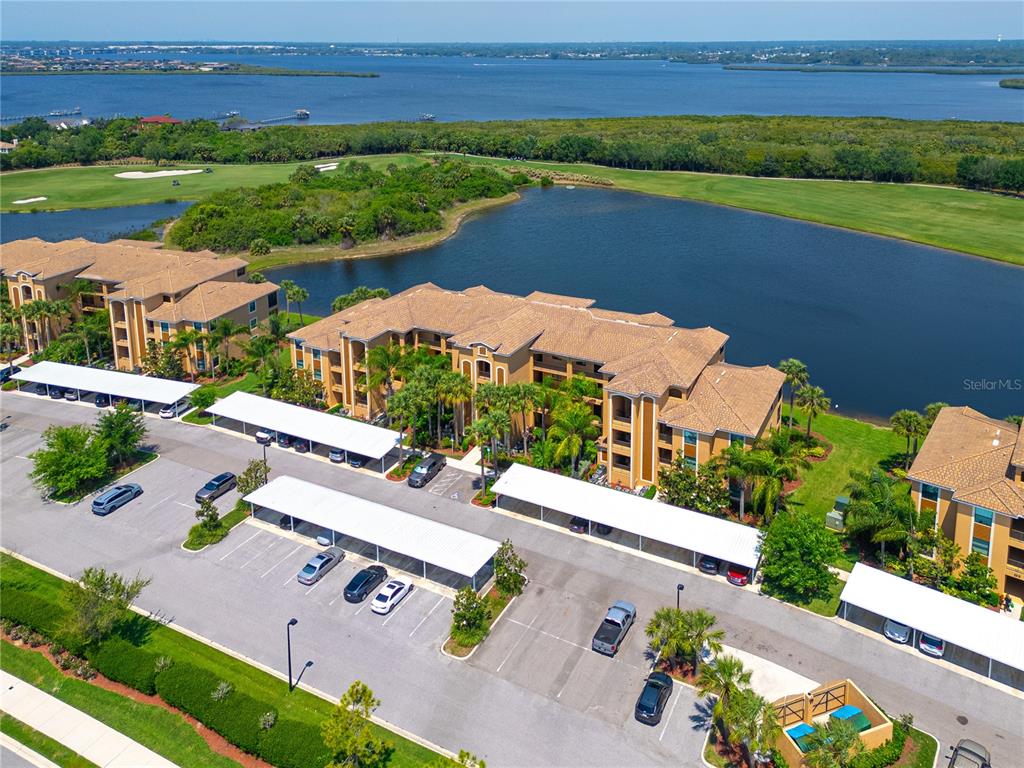 an aerial view of a house with a garden and lake view