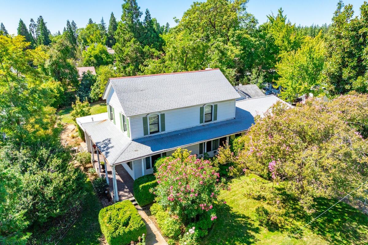 an aerial view of a house with swimming pool and garden