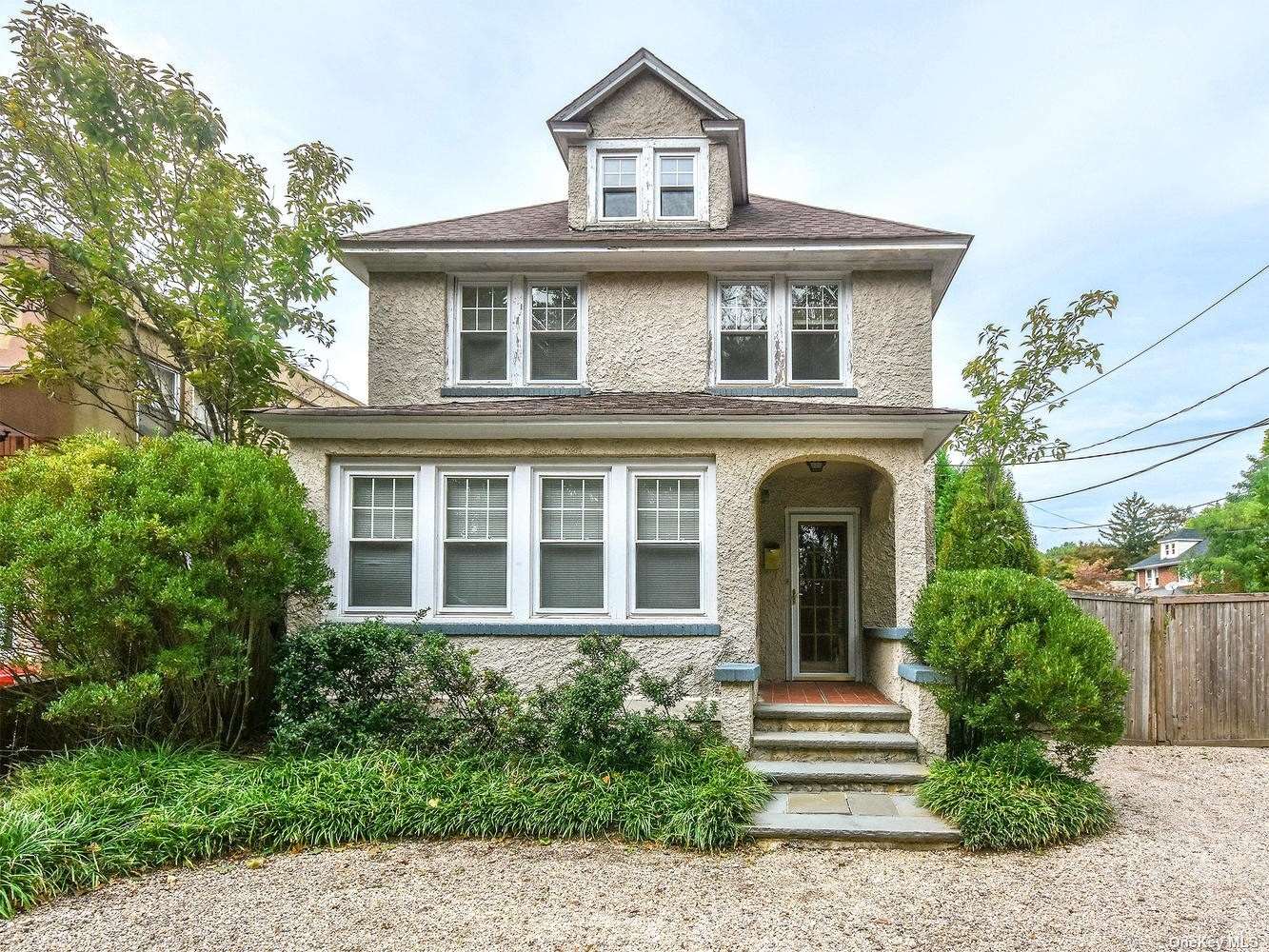 front view of a house with a yard