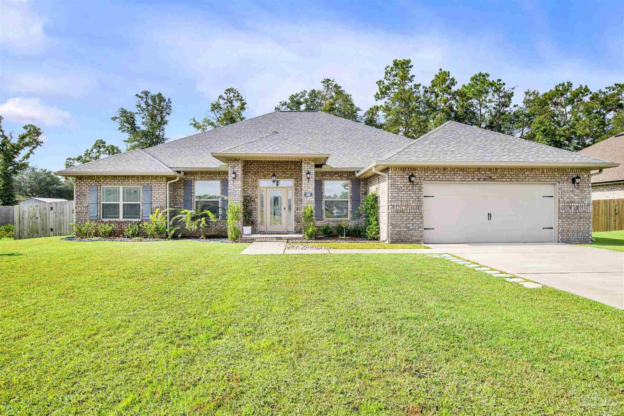 a front view of house with yard and outdoor seating