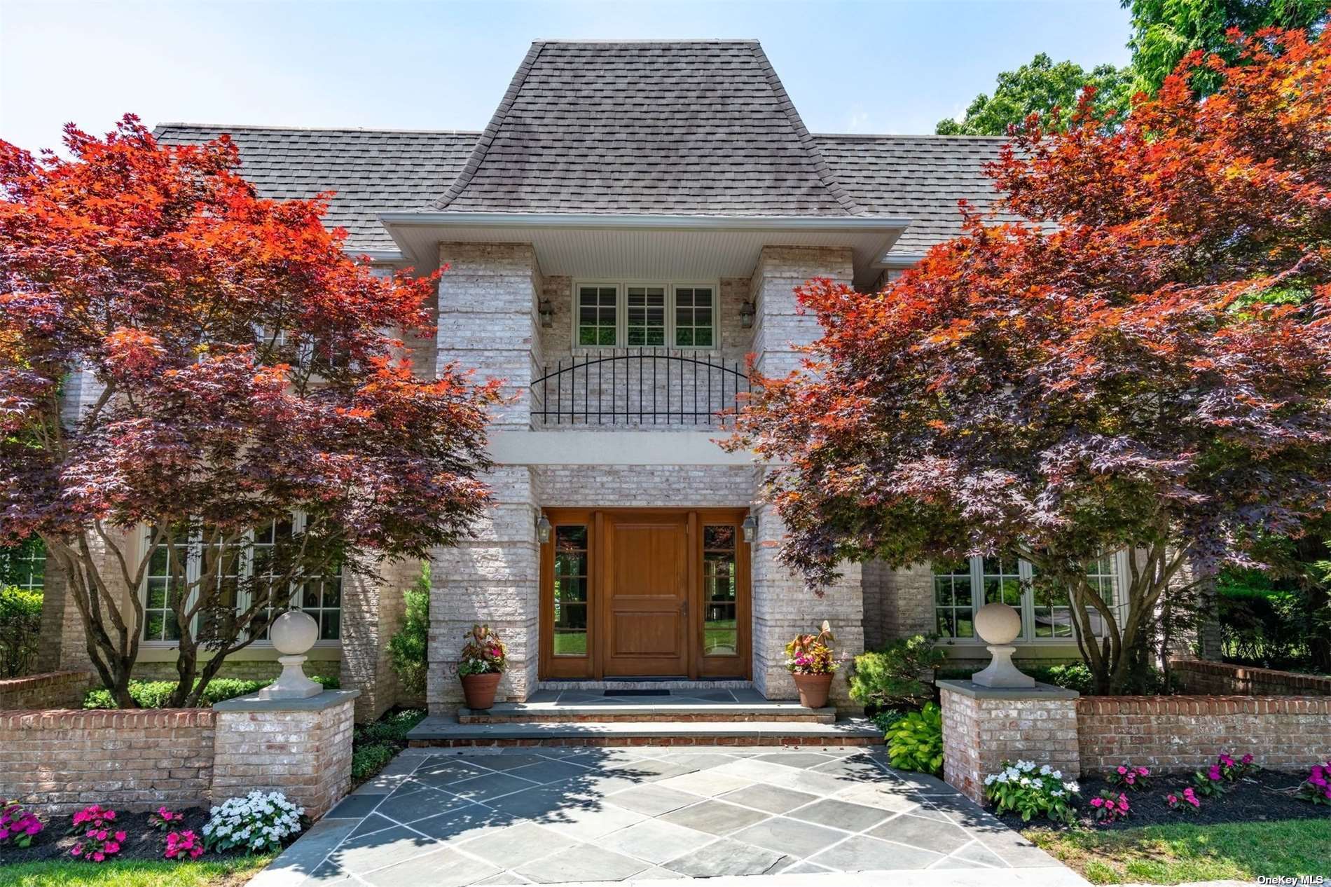 a front view of a house with a garden