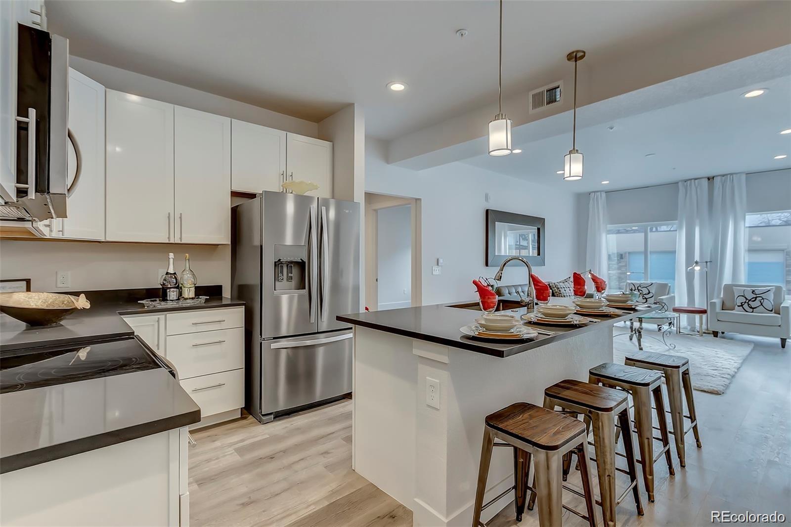 a kitchen view with white cabinets and stainless steel appliances