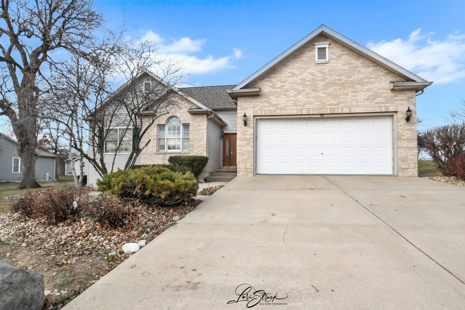 a front view of a house with a yard and garage