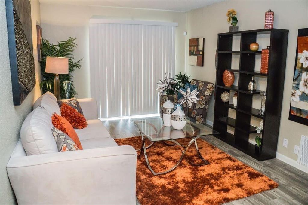 a living room with furniture and a book shelf