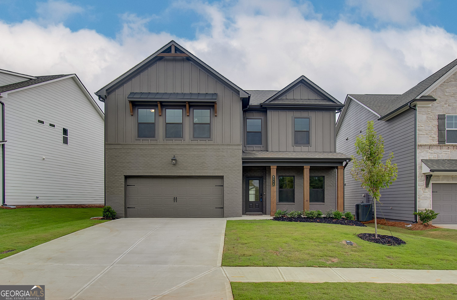 a front view of a house with a yard and garage