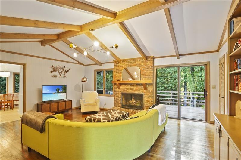 a living room with furniture a fireplace and a large window