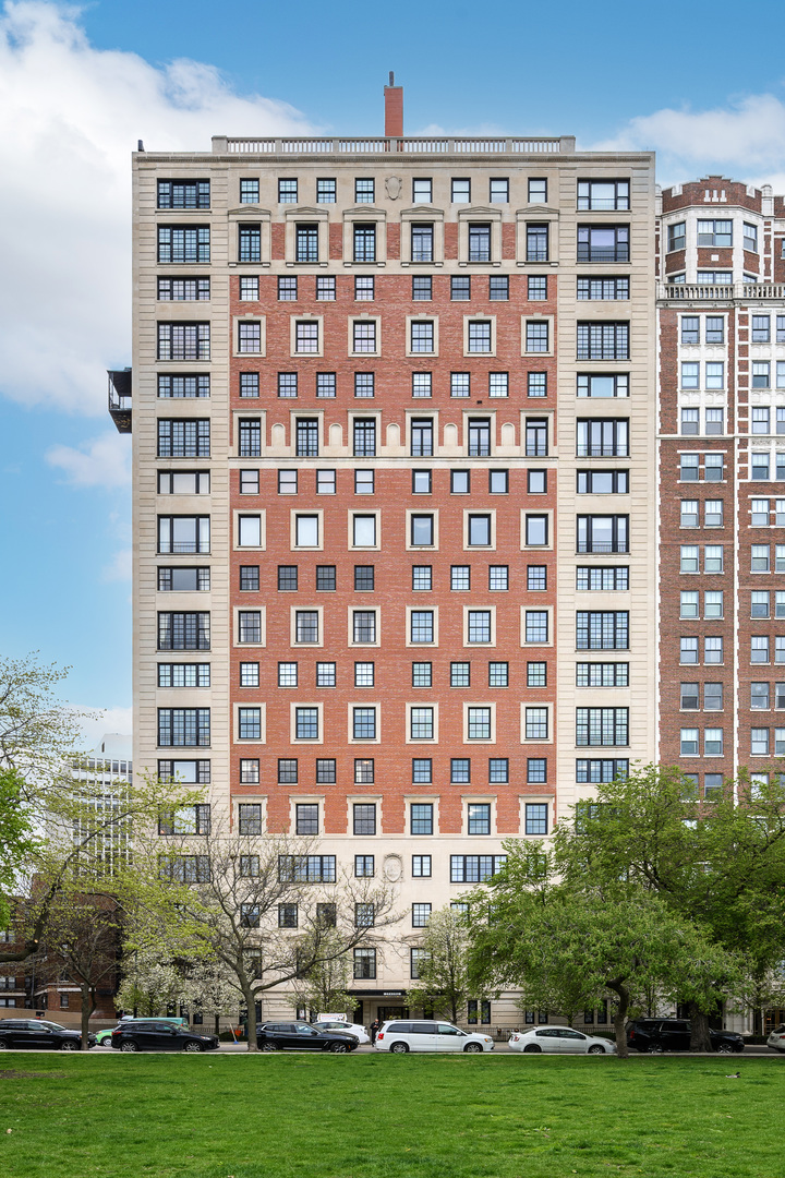 a front view of a building with windows and garden space